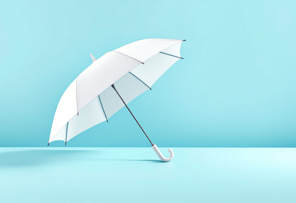 Parapluie blanc fermé posé à plat sur un fond bleu clair